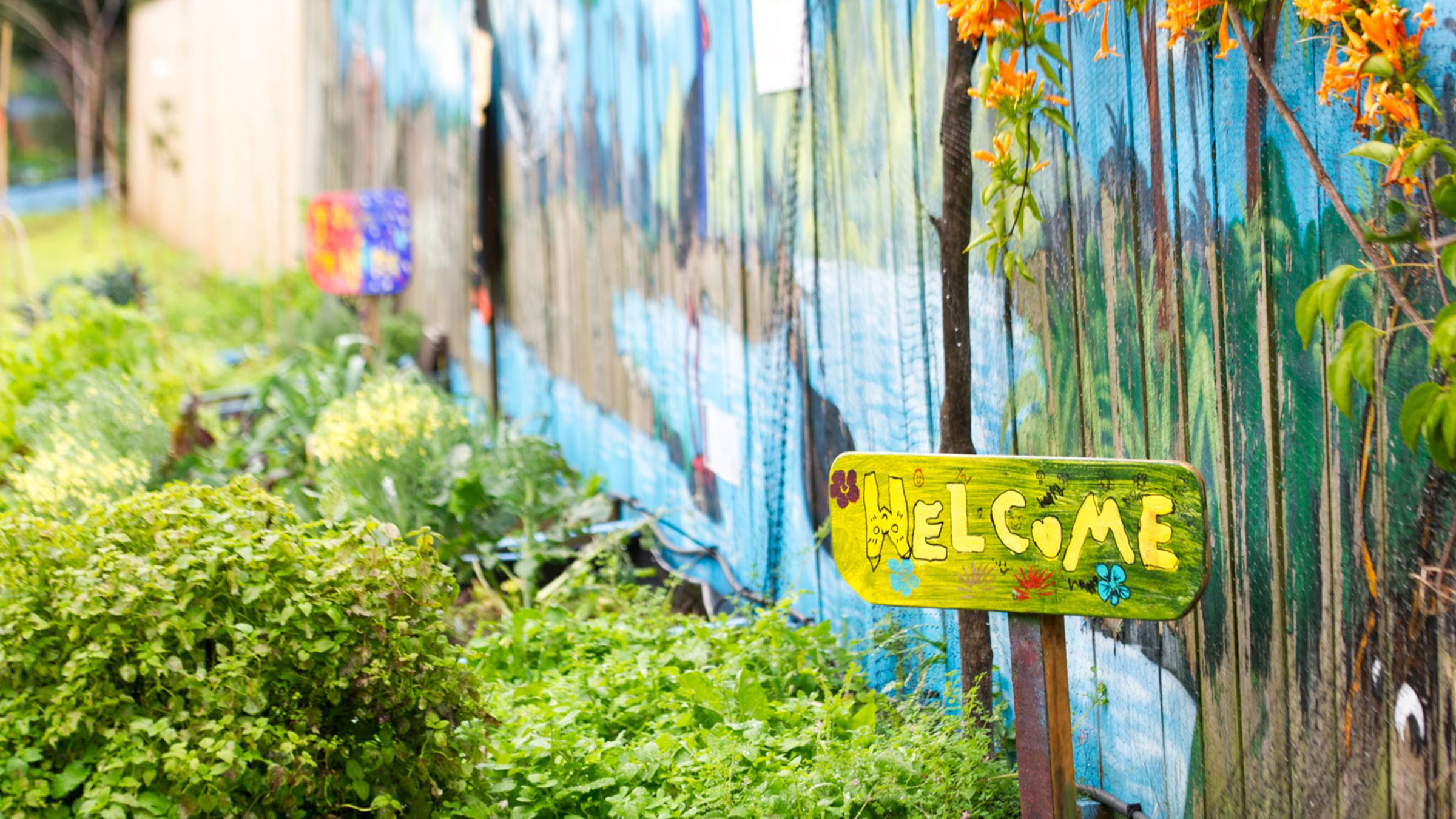 School garden with painted welcome sign