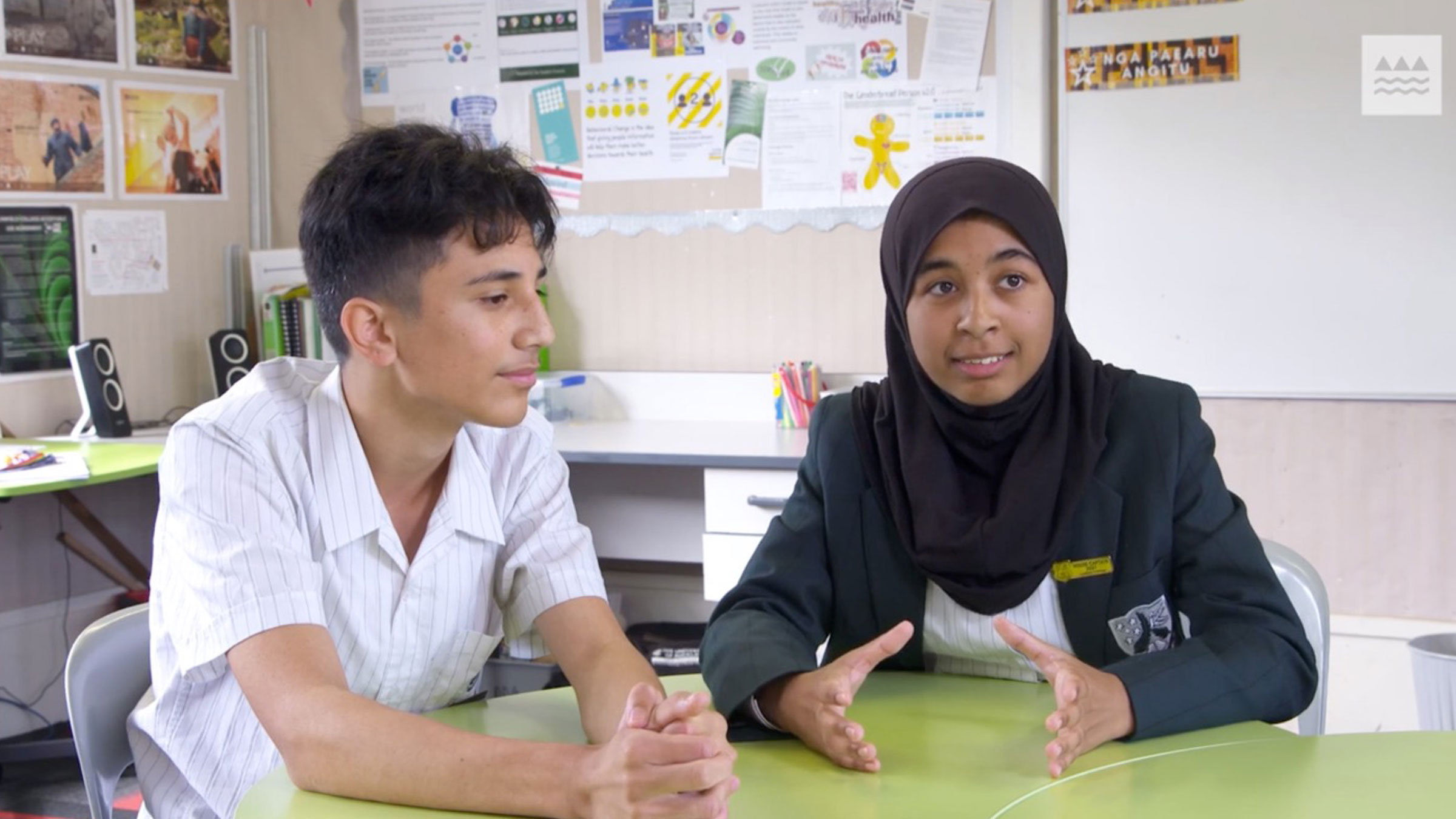 Two students being interviewed in a classroom setting