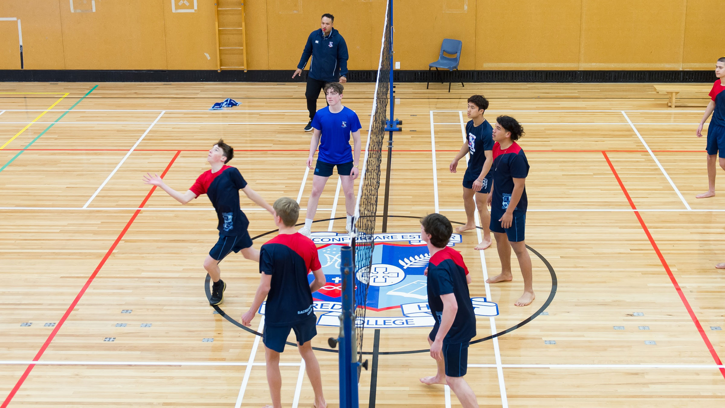 Secondary school students playing volleyball